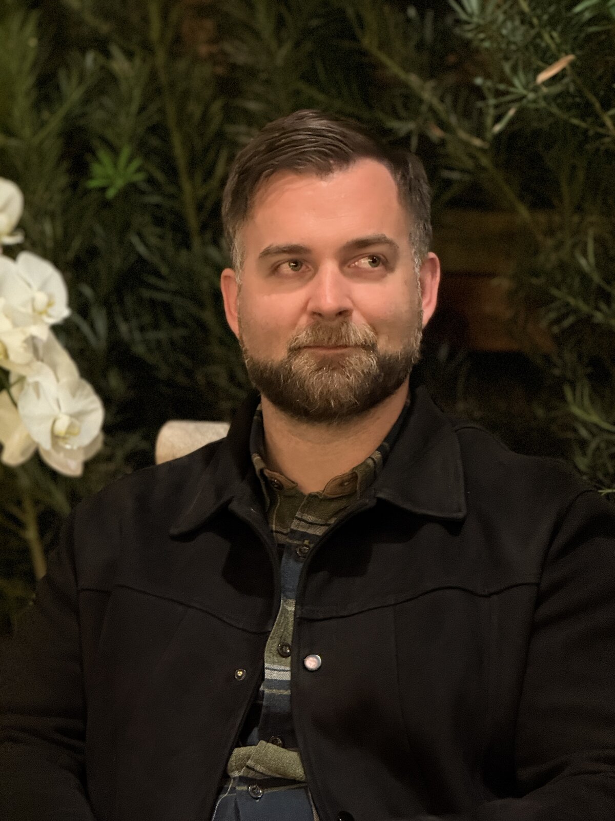 Martin, black jacket, plant wall