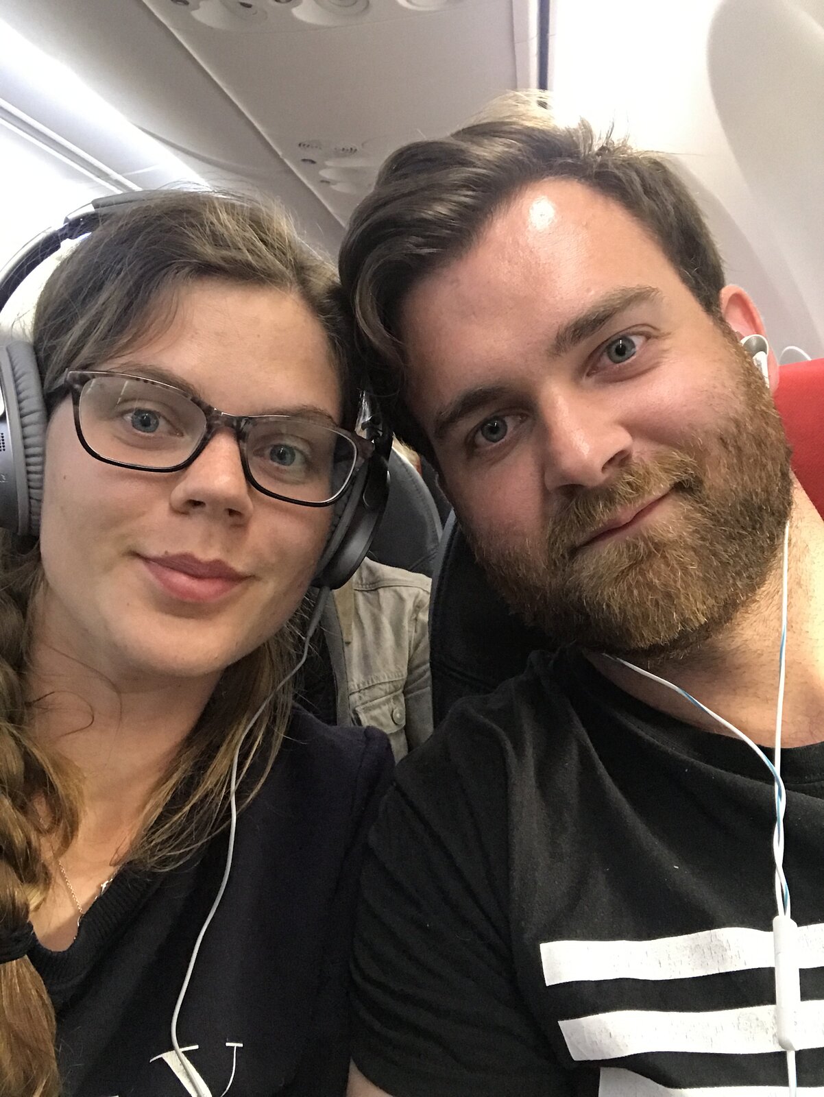 Plane selfie — Erica and Martin with headphones