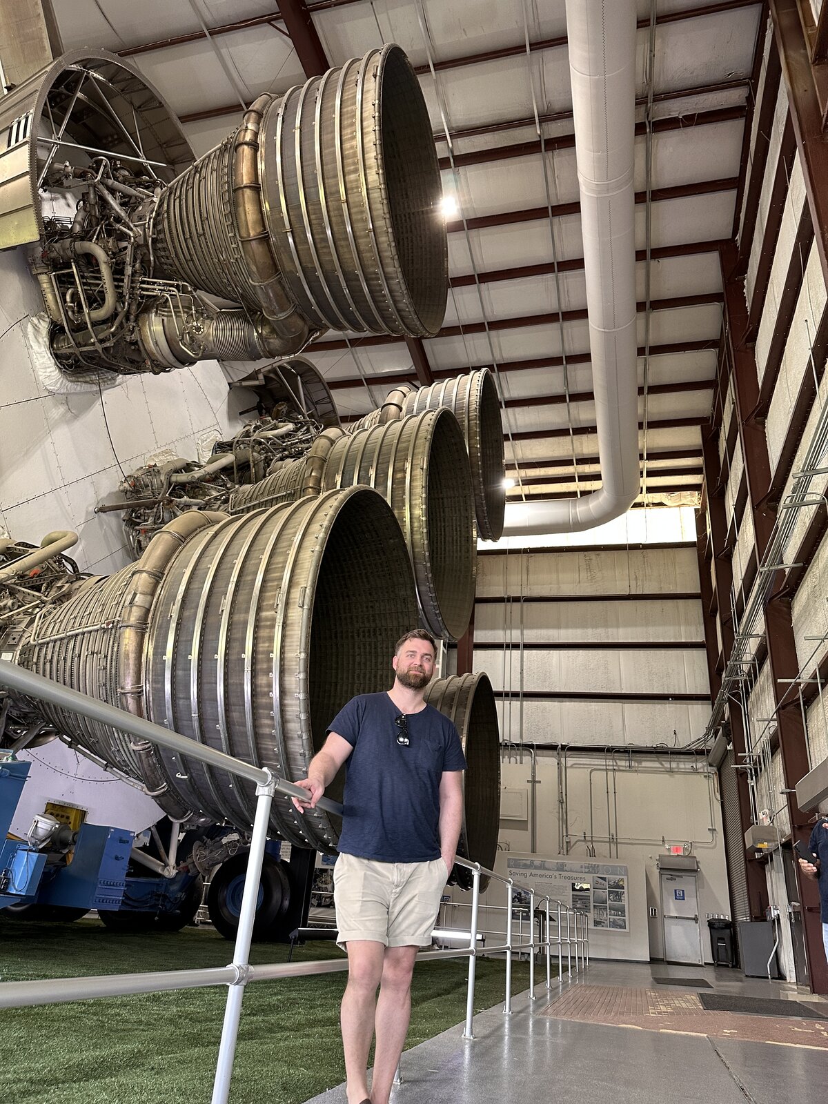 Martin standing next to a Saturn V rocket engine