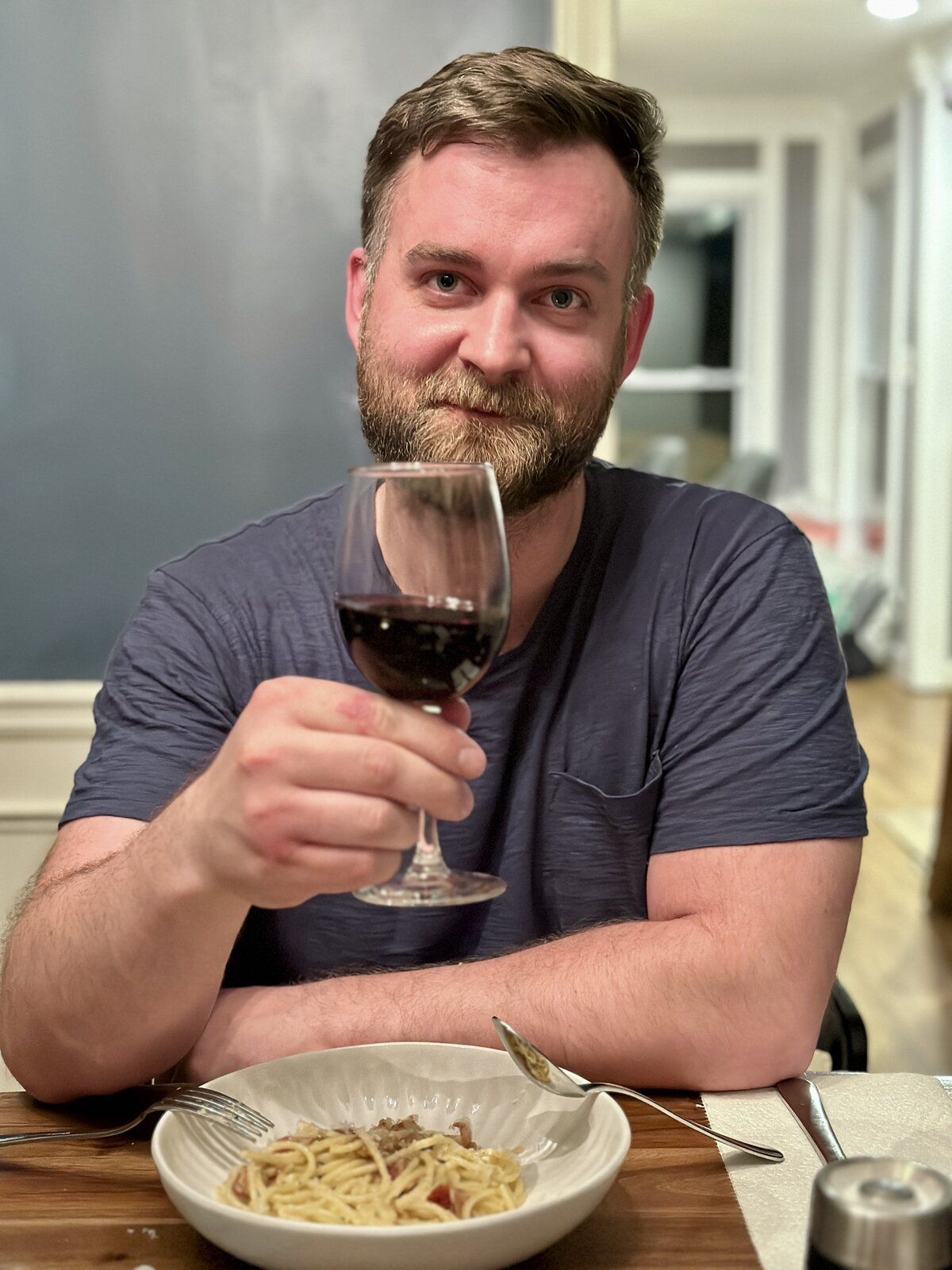 Martin with red wine and pasta — looking smug